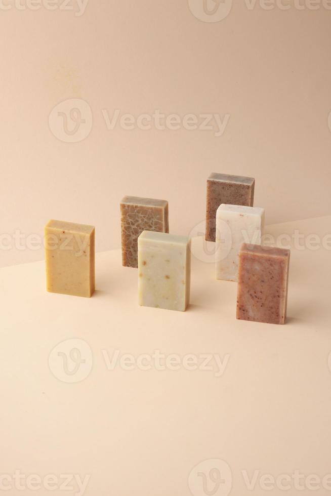 Composition with soap on pastel beige background. Close up, copy space. photo