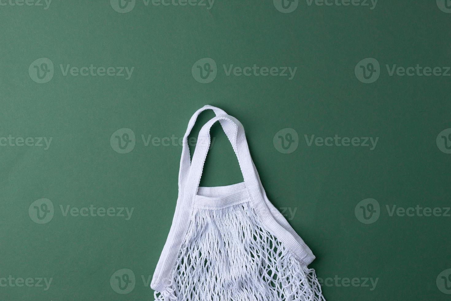 Zero waste, sustainable and eco-friendly lifestyle. Basket on green background. Flat lay, copy space photo