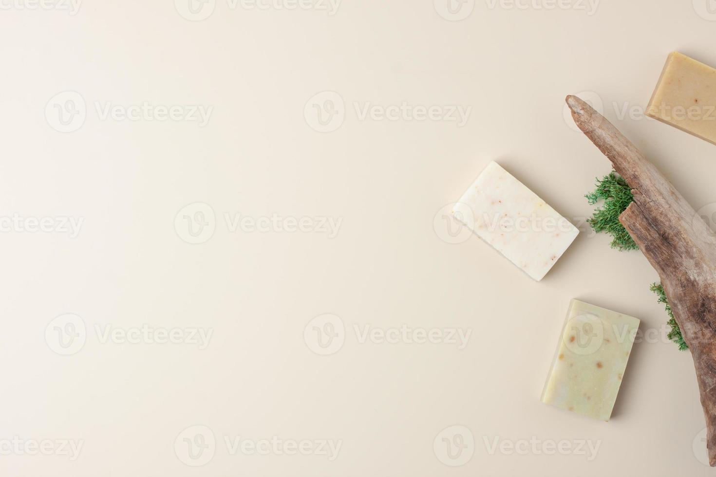 Soap and wood on beige background. Flat lay, copy space. photo