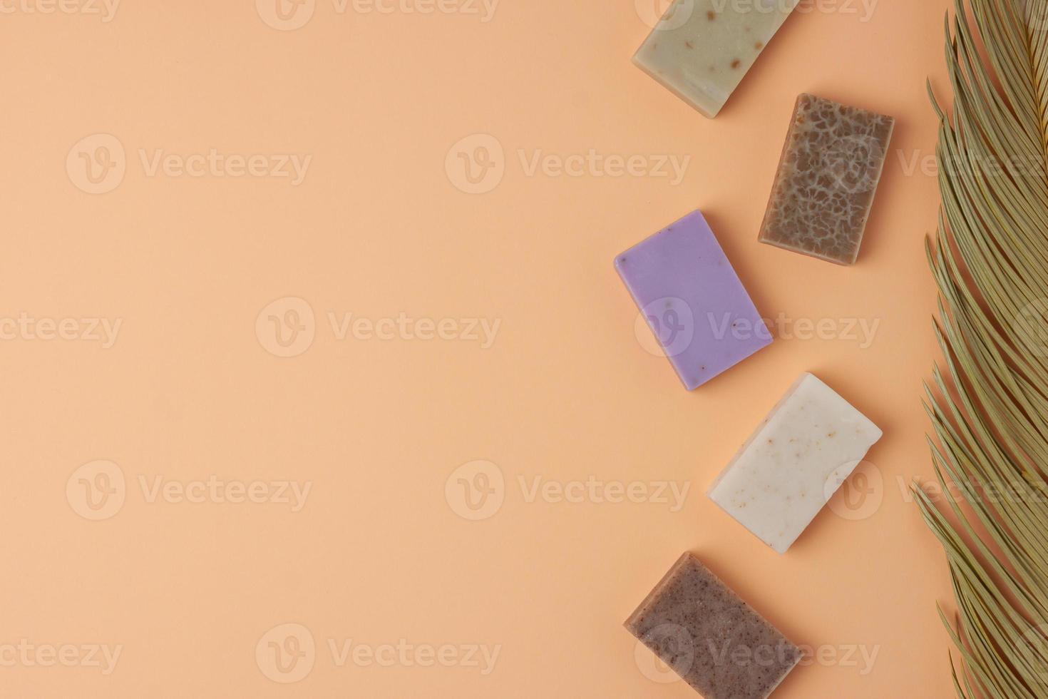 Soap and palm on beige background. Flat lay, copy space. photo