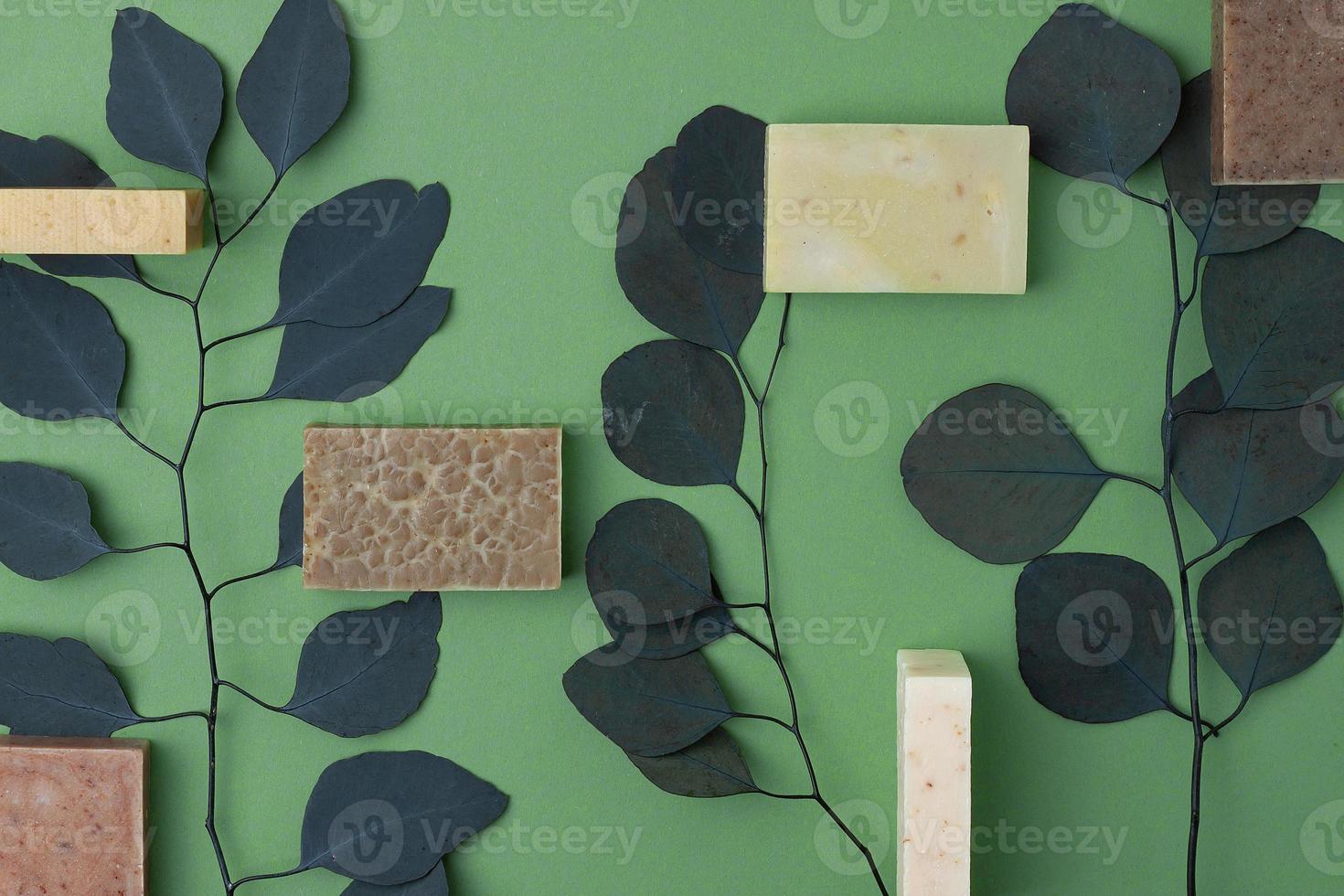 Soap with eucalyptus on green natural background. Flat lay, copy space. photo