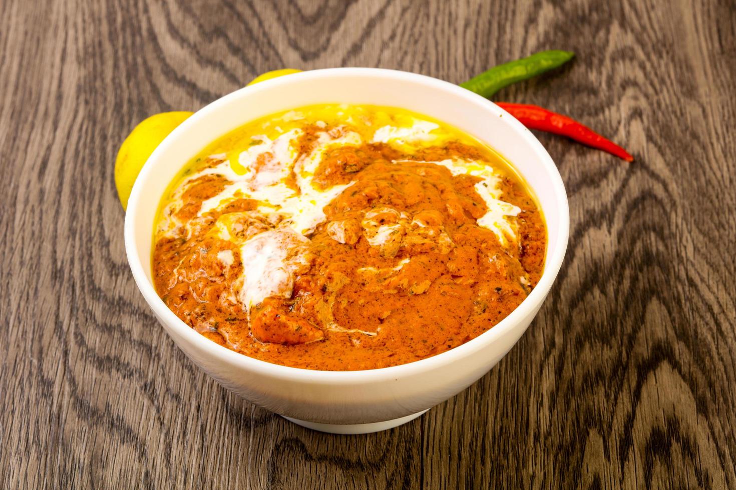 Butter chicken on wood photo
