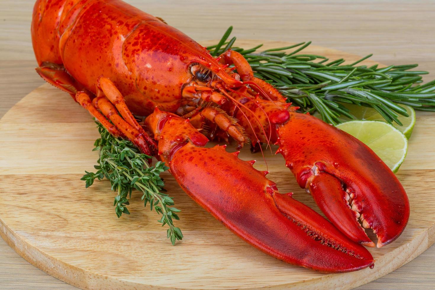 Boiled lobster on wooden board and white background photo