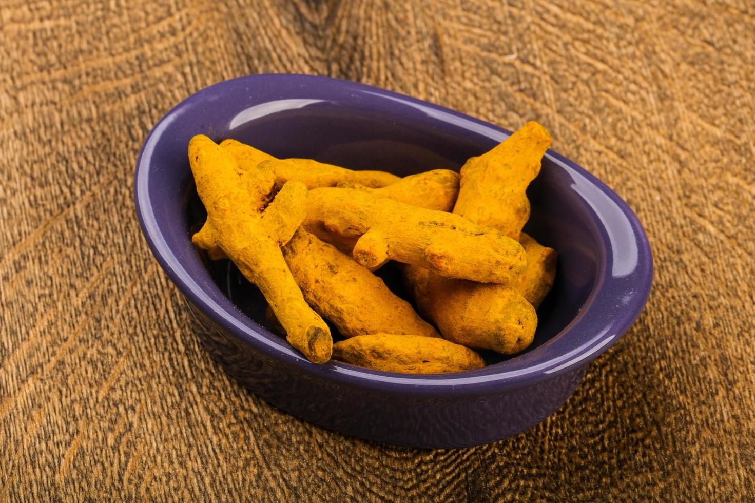 Tumeric roots on wood photo