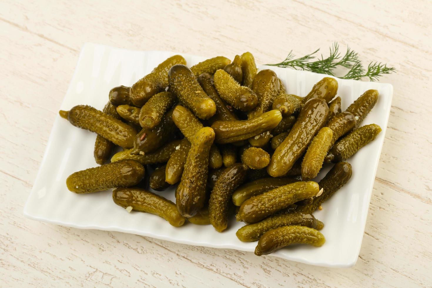 Pickled cucumbers dish view photo