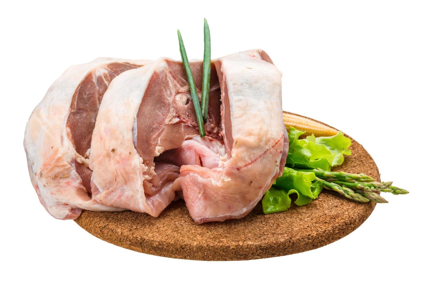 Raw lamb on wooden board and white background photo