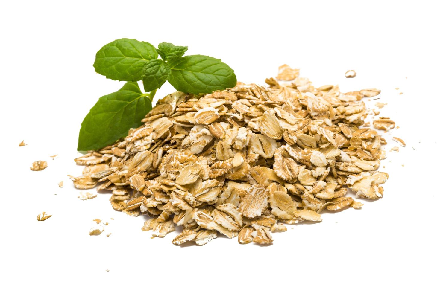 Oats pile on white background photo