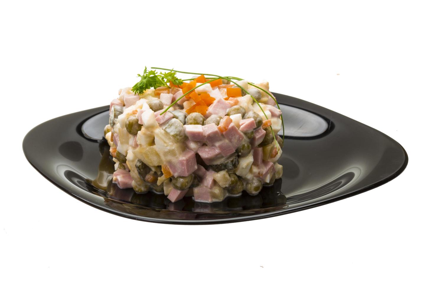 Russian Salad on the plate and white background photo