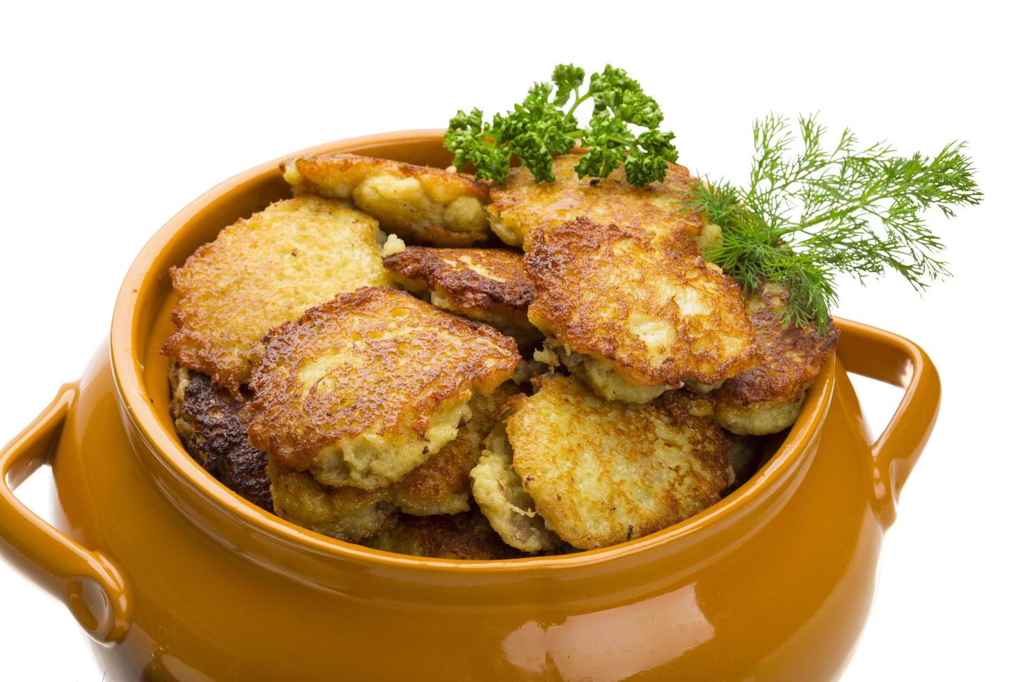 Potato pancakes in a bowl on white background photo