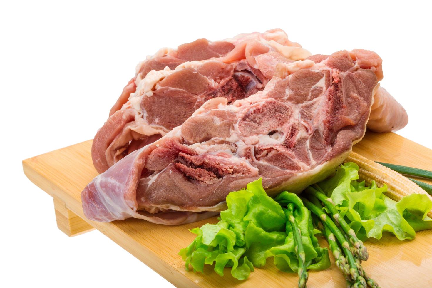 Raw lamb on wooden board and white background photo
