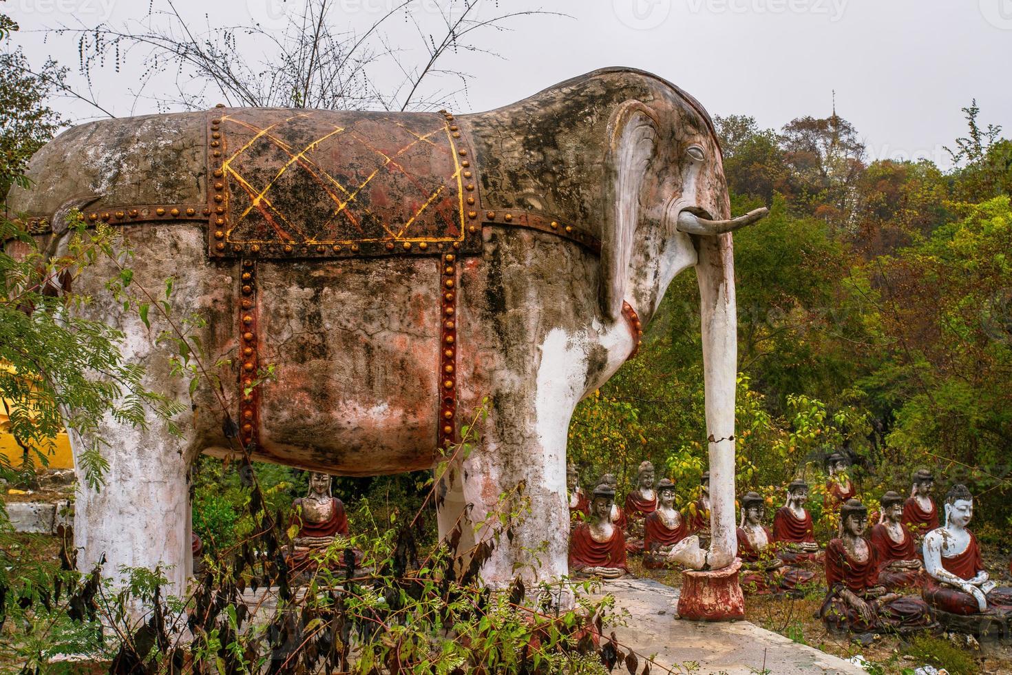 Elephant sculpture in old temple with numerous of old Image of Buddha on mountain in Mingun, Sagaing Region, Myanmar photo