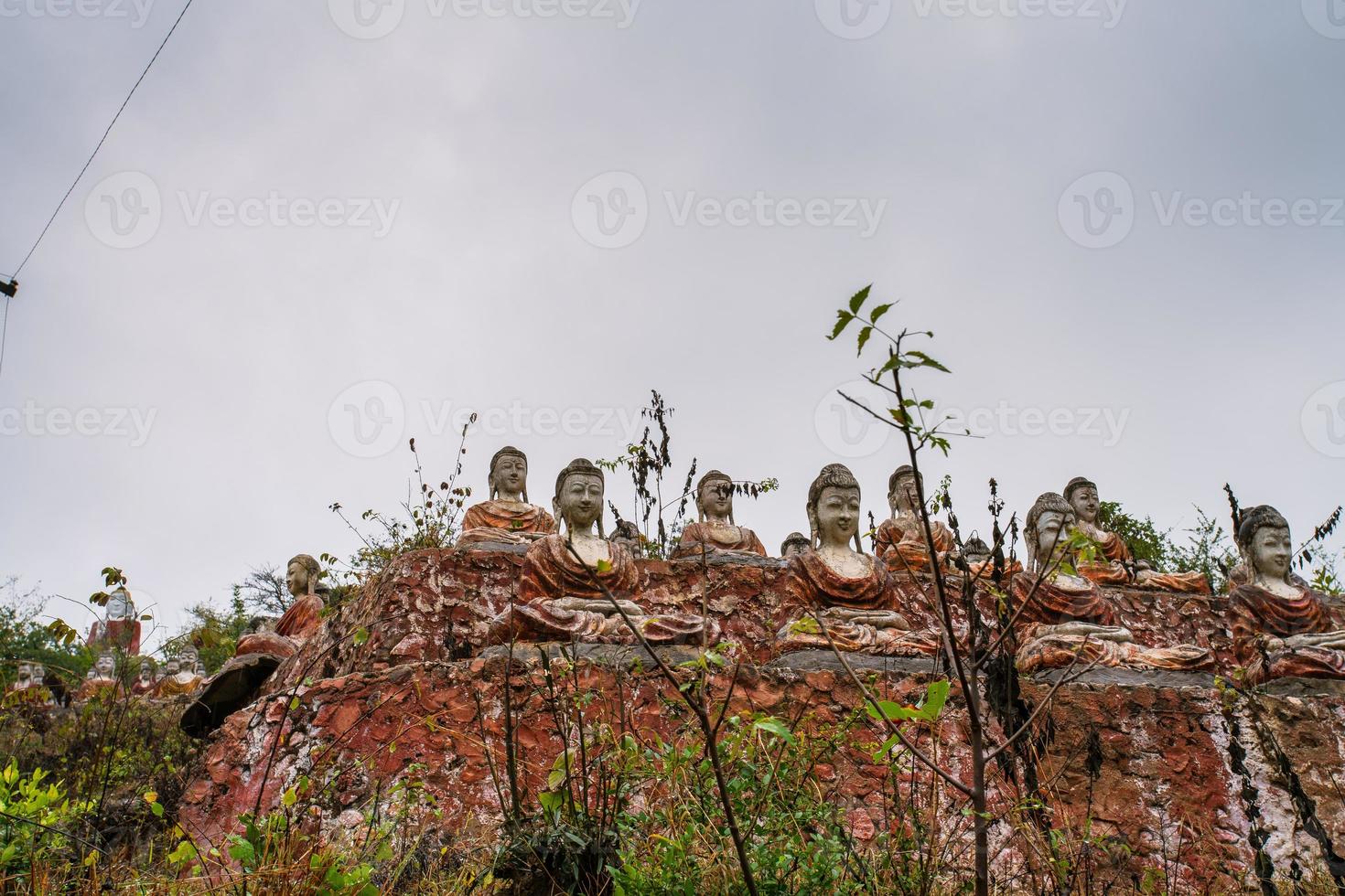 Old temple with numerous of old Image of Buddha on mountain in Mingun, Sagaing Region, Myanmar photo
