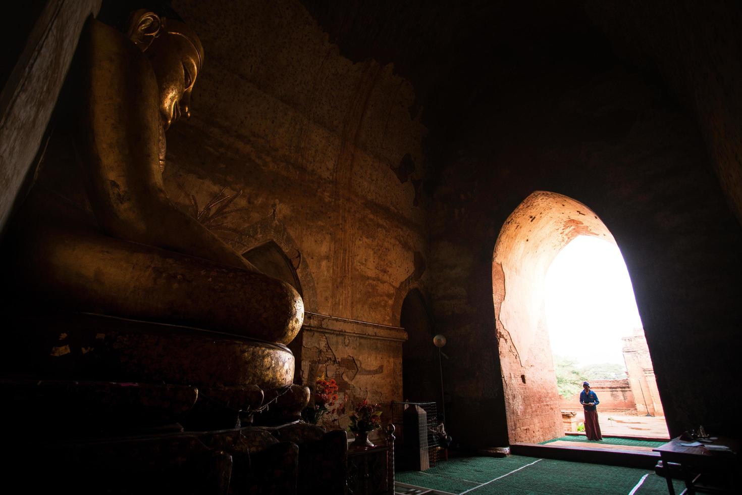 Bagan, Mandalay region, Myanmar - January 9, 2019 - People come and pray to an image of Buddha in Dhammayangyi Temple photo