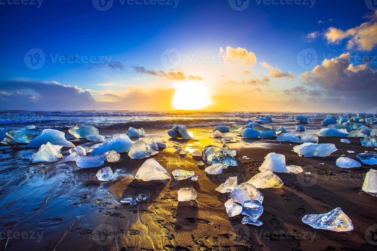 Ice rock with black sand beach at Jokulsarlon beach, or Diamond beach, in southeast Iceland photo