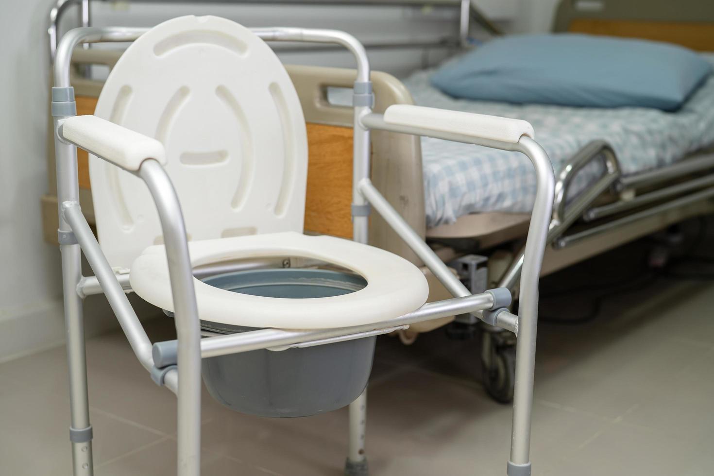 Flush toilet and shower chair in bathroom for old elder people. photo