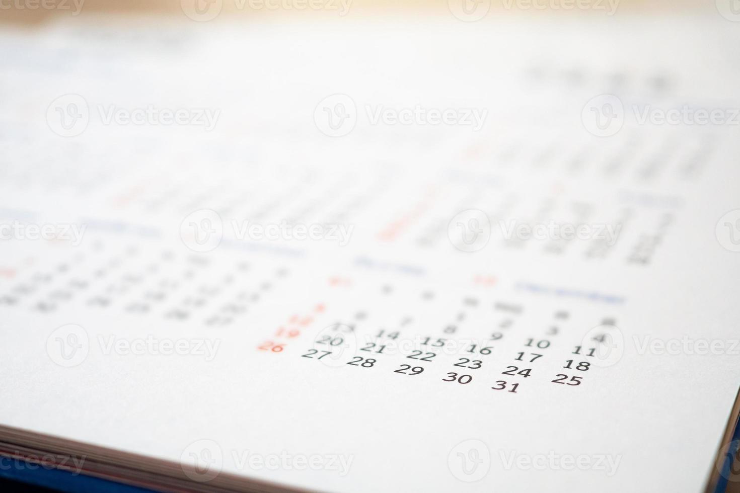 Close up calendar page dates abstract blurred background business planning appointment meeting concept photo