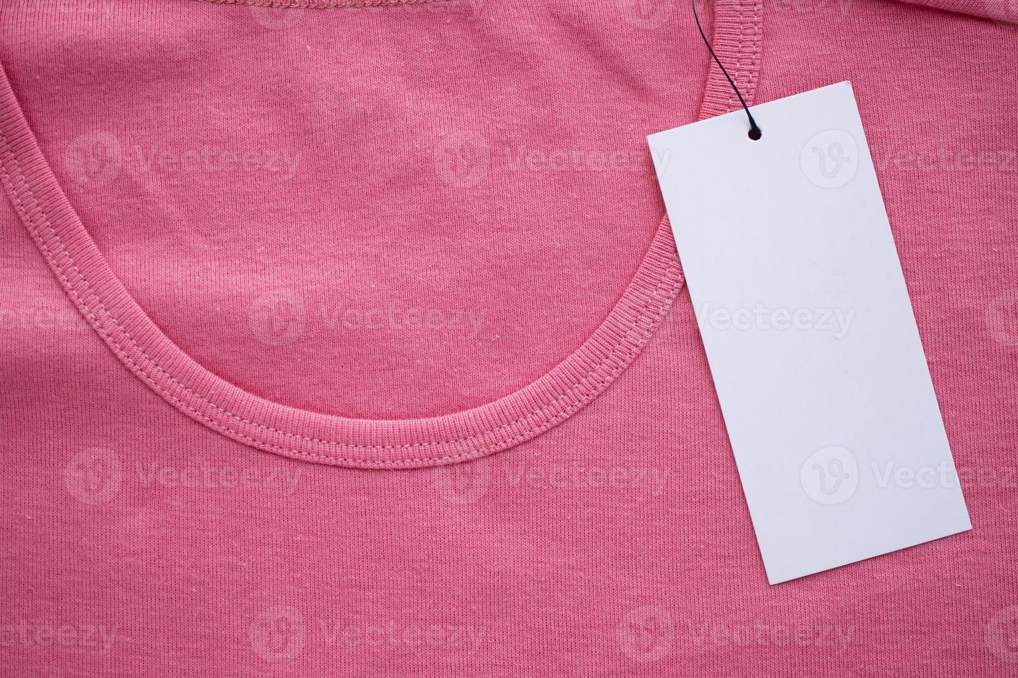 Blank white clothes tag label on new shirt photo