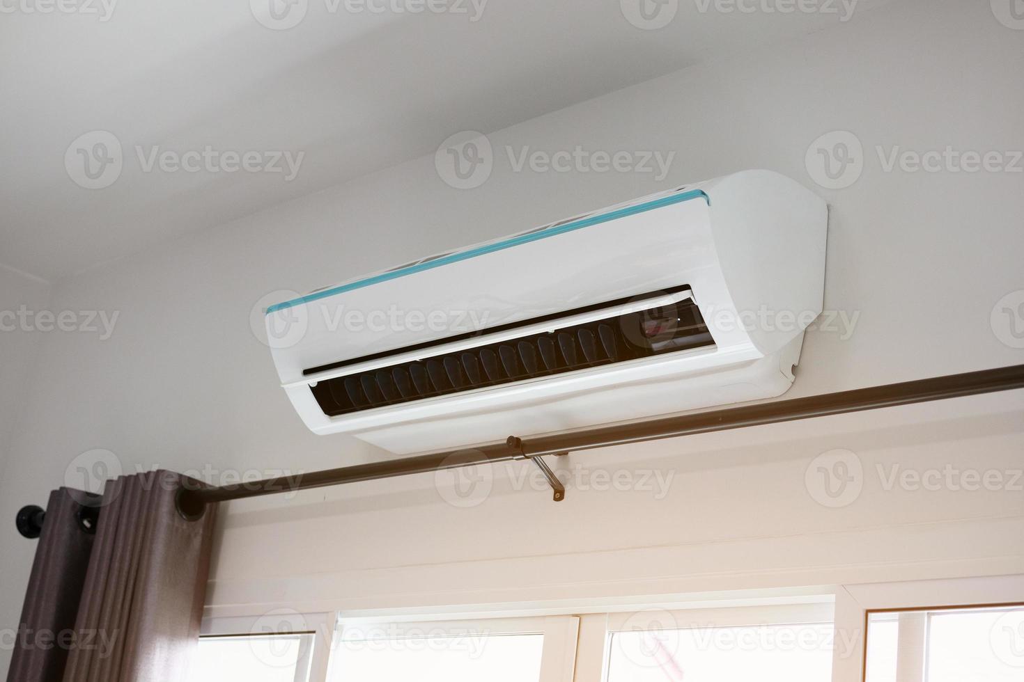 Air conditioner on white wall room interior background photo