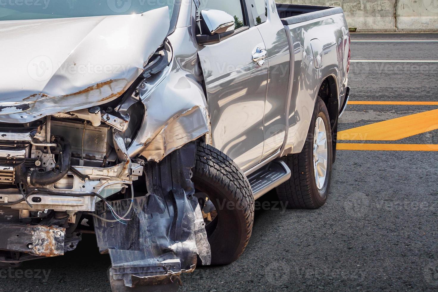 Pickup truck car crash damaged from accident on the road photo