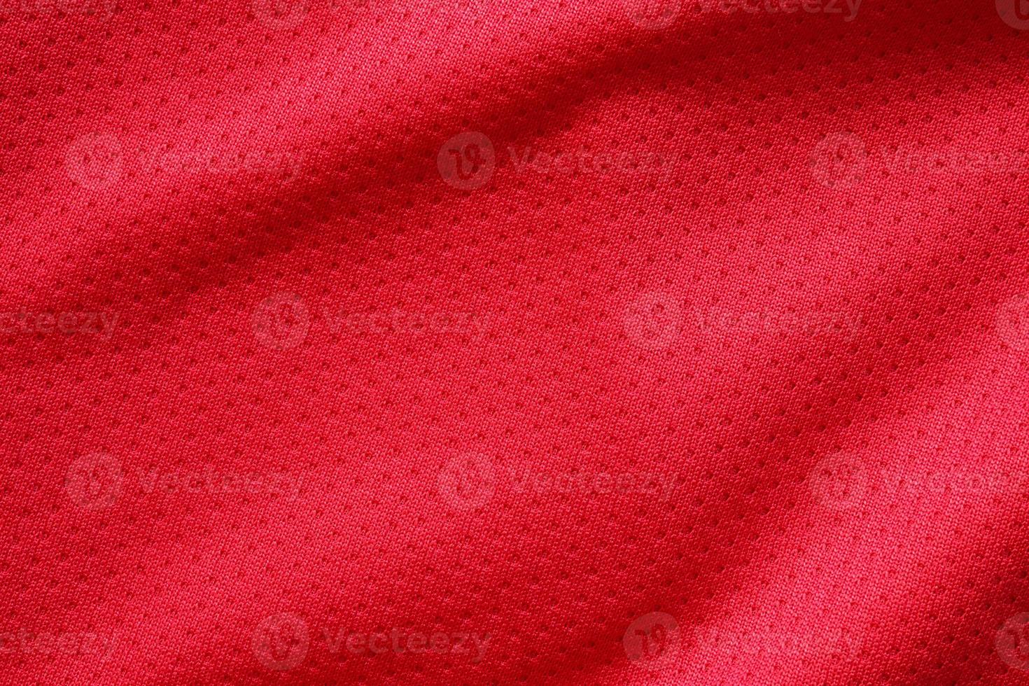 Red sports clothing fabric football shirt jersey texture close up photo