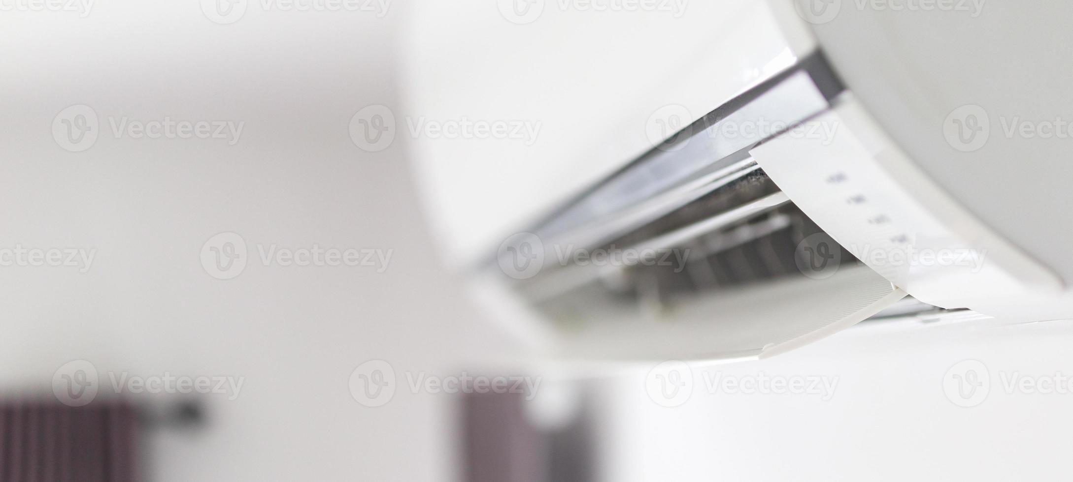 Air conditioner on white wall room interior background photo