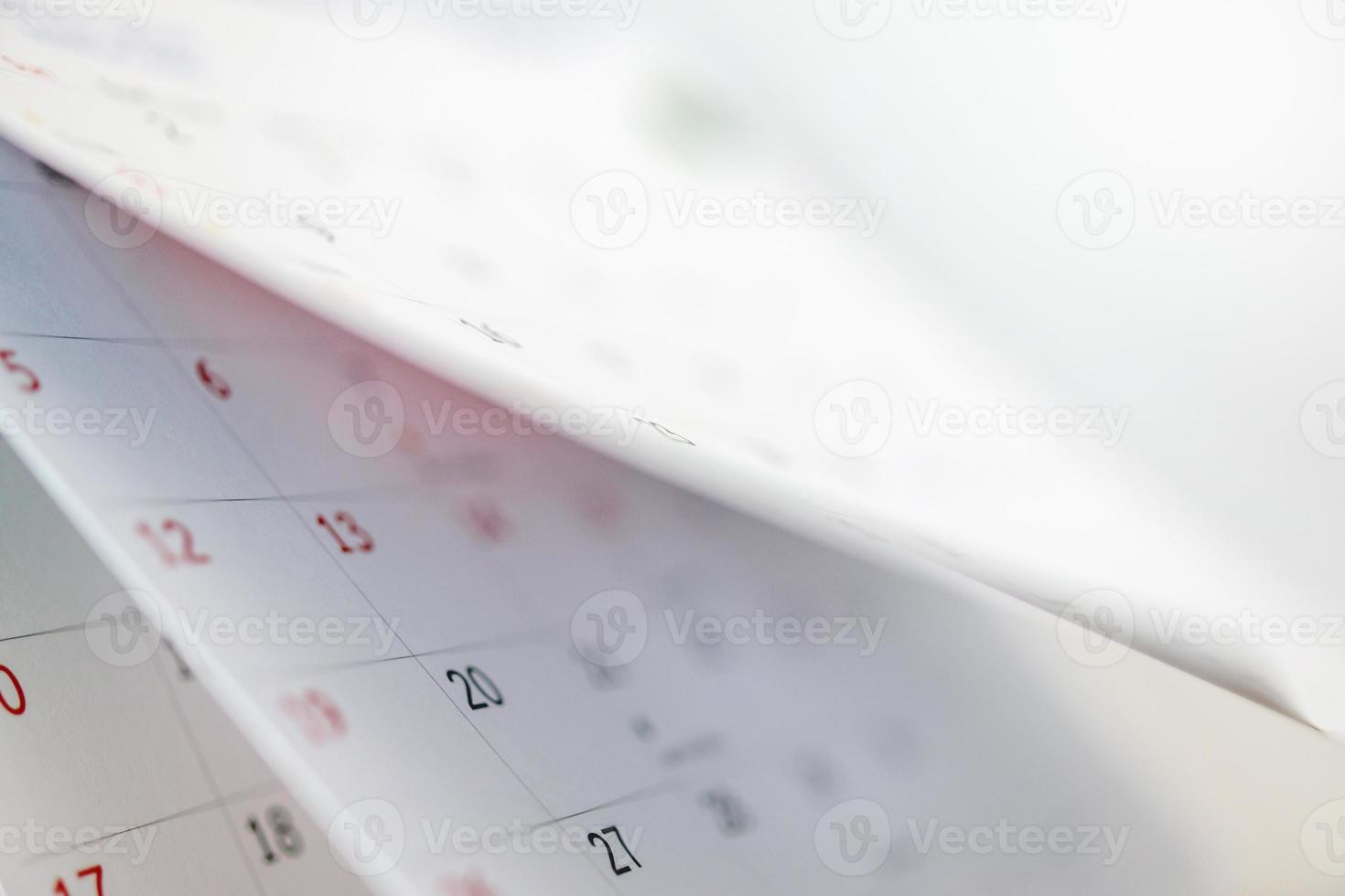 Calendar page flipping sheet close up on office table interior background business schedule planning appointment meeting concept photo