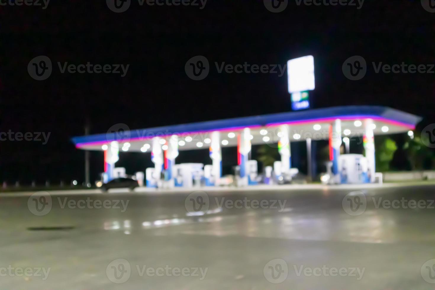 Petrol gas station at night time blurred background with bokeh light photo