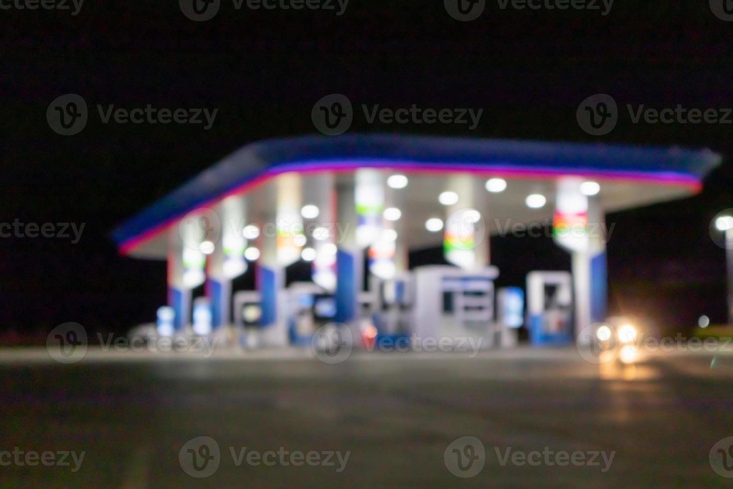 Petrol gas station at night time blurred background with bokeh light photo