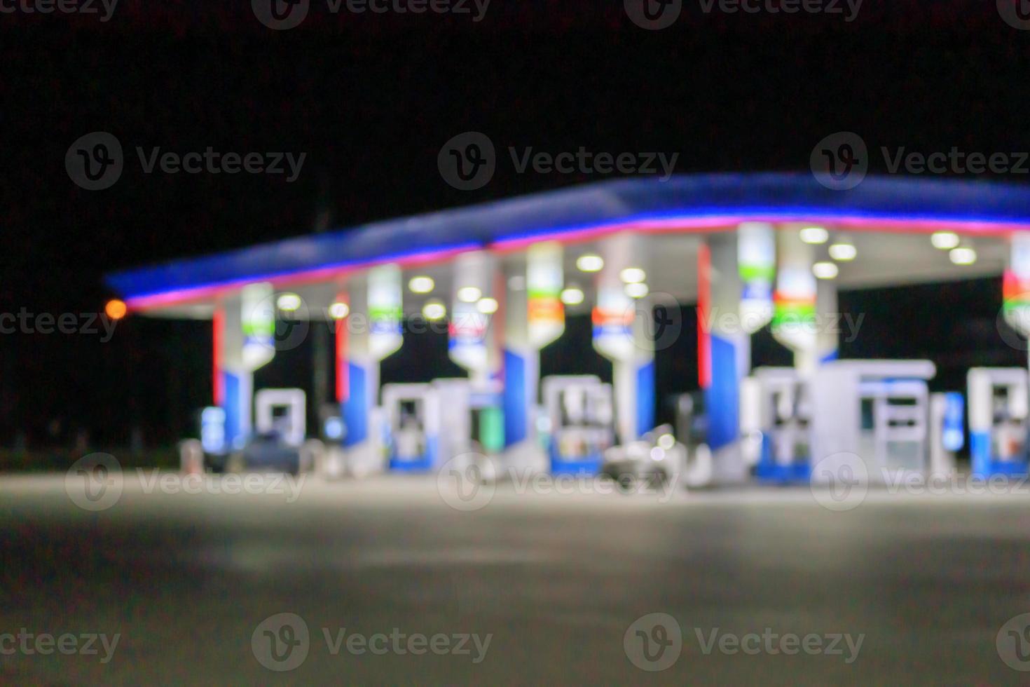 Petrol gas station at night time blurred background with bokeh light photo