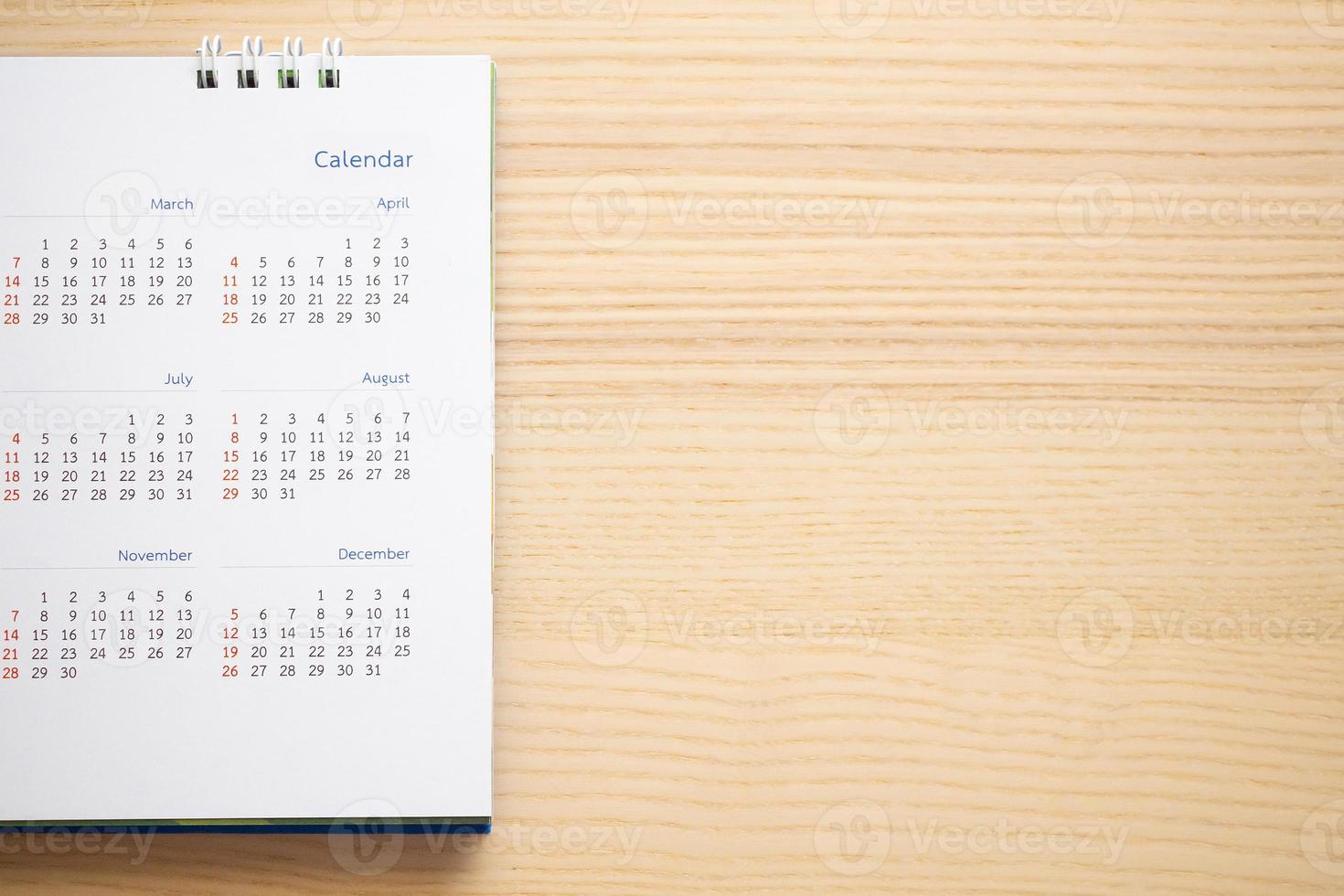 calendar page close up on wood table background business planning appointment meeting concept photo