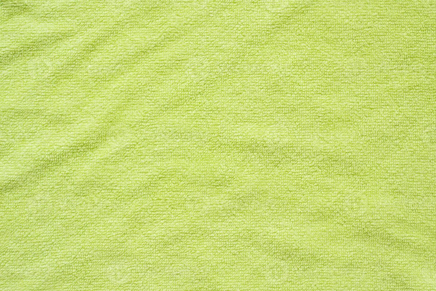 Green towel fabric texture surface close up background photo