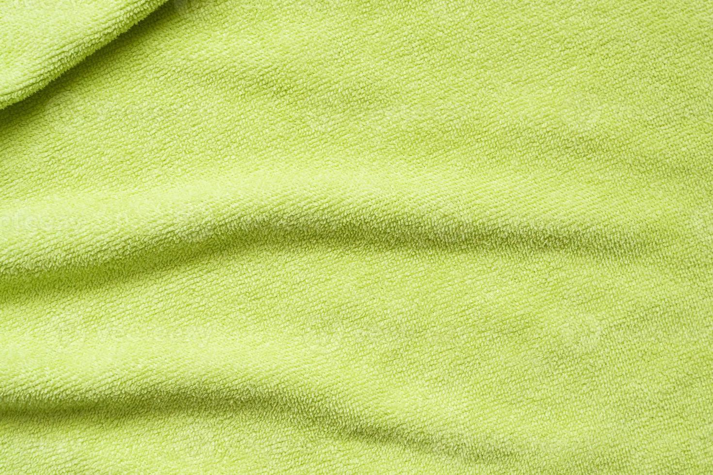 Green towel fabric texture surface close up background photo