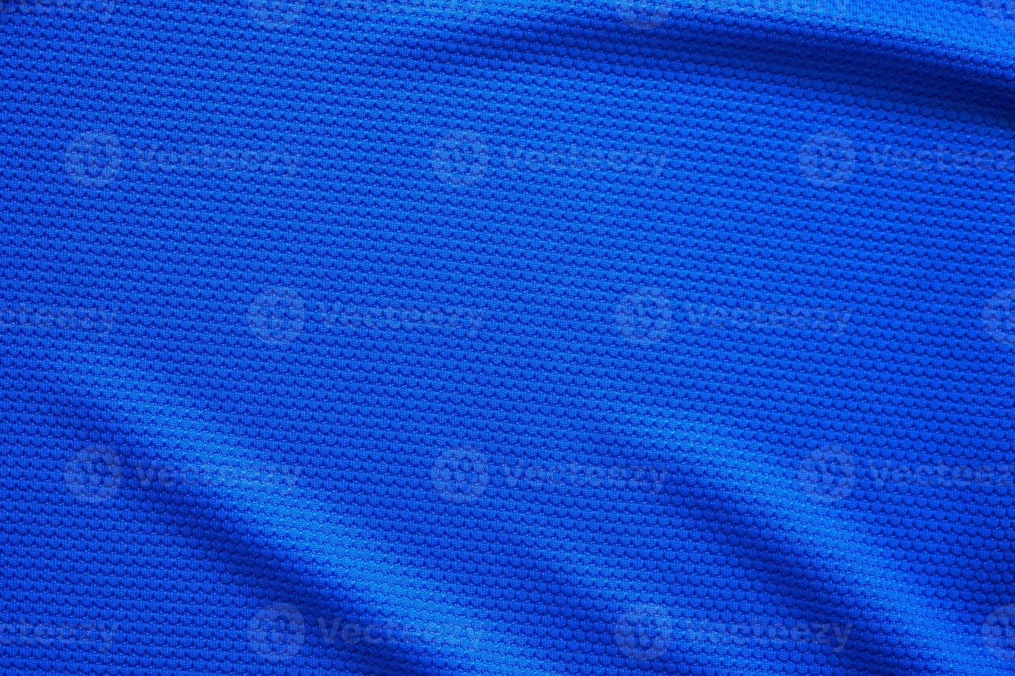 Blue football jersey clothing fabric texture sports wear background, close up top view photo
