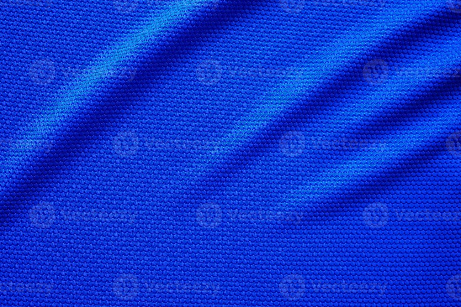 Blue football jersey clothing fabric texture sports wear background, close up top view photo