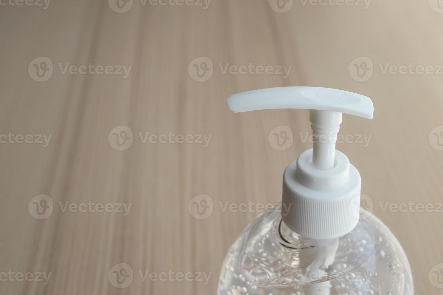 Alcohol sanitizer gel hand wash on wood table for covid-19 Coronavirus prevention concept photo