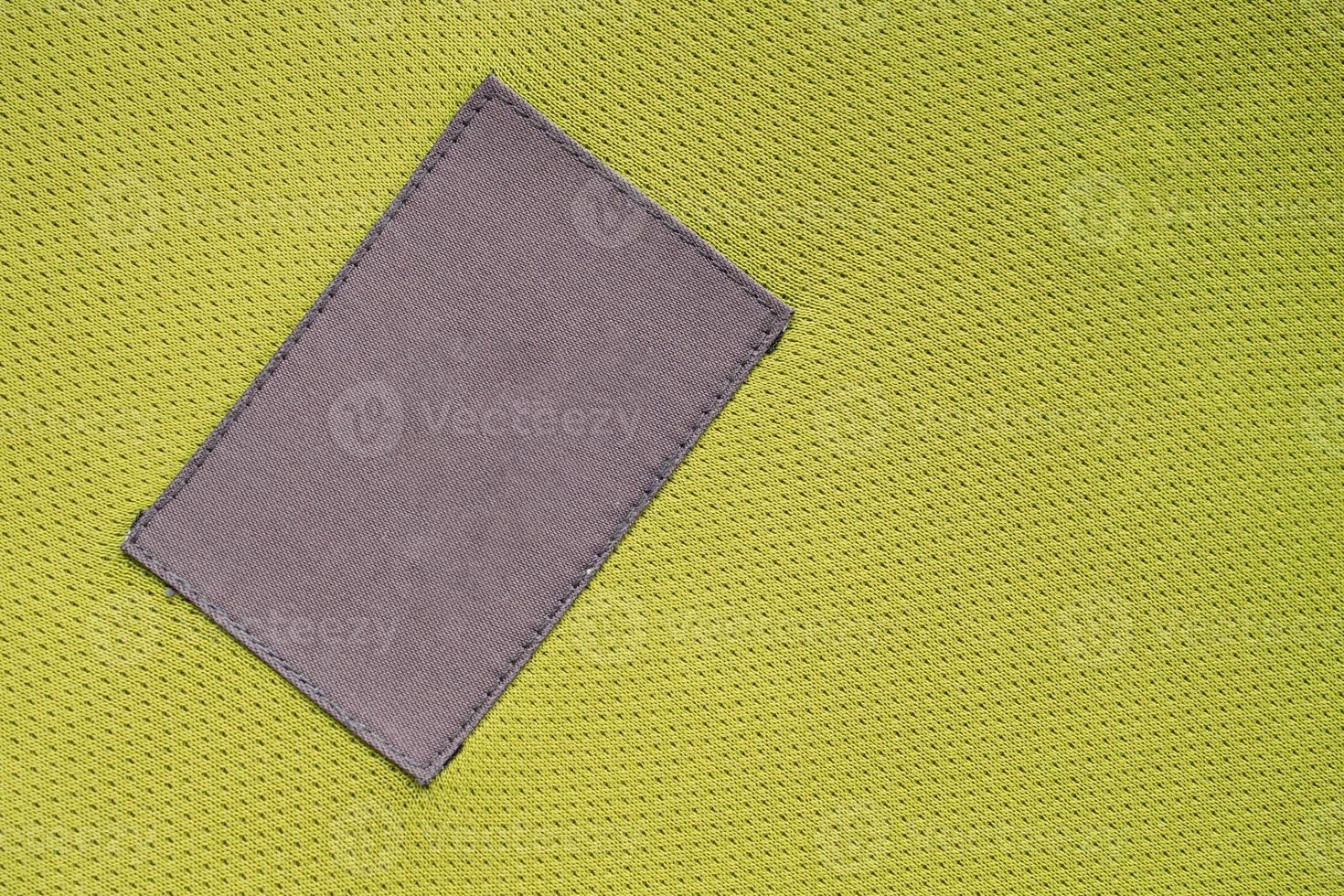 laundry care clothing label patch on polyester fabric jersey sport texture photo