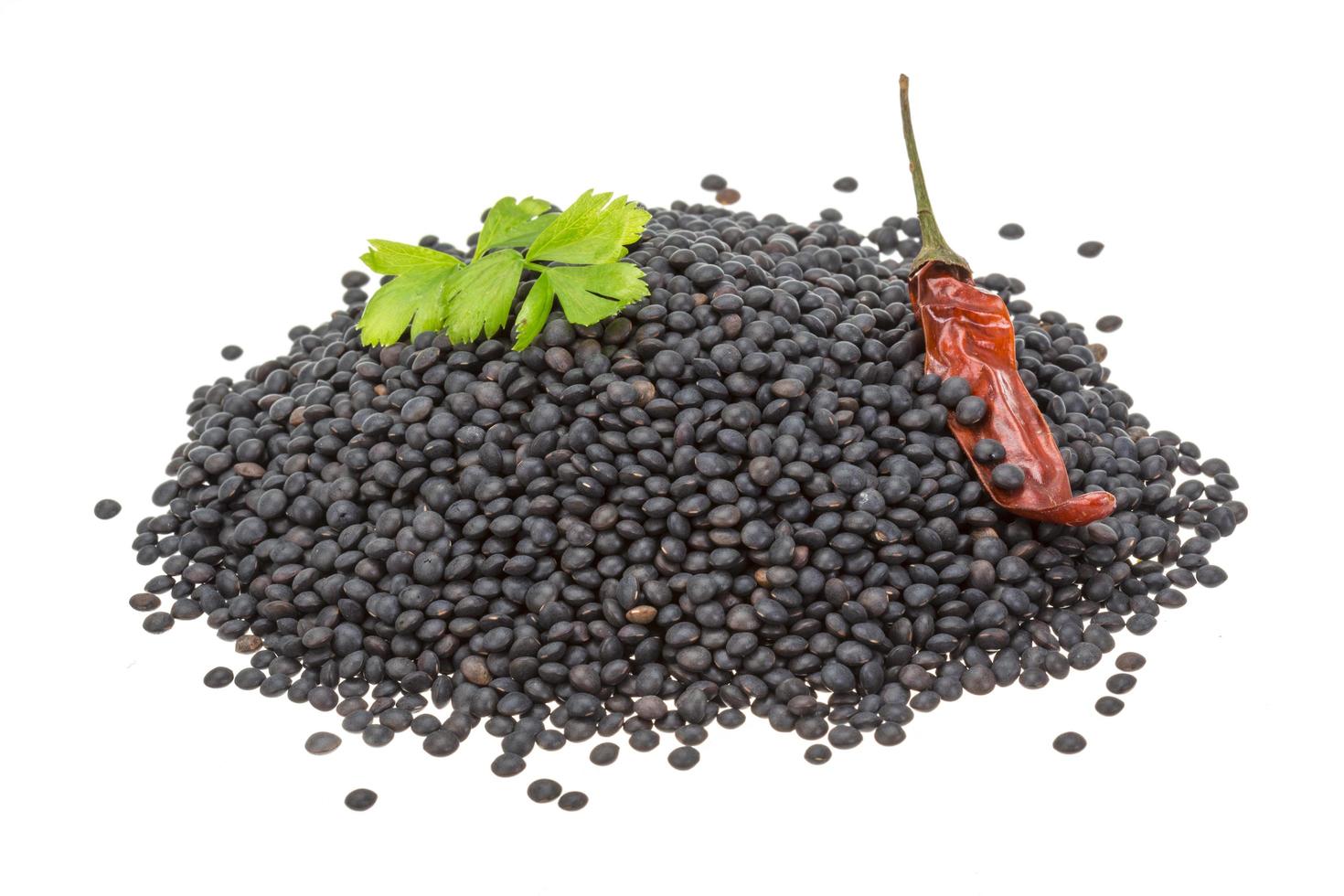Black lentils on white photo