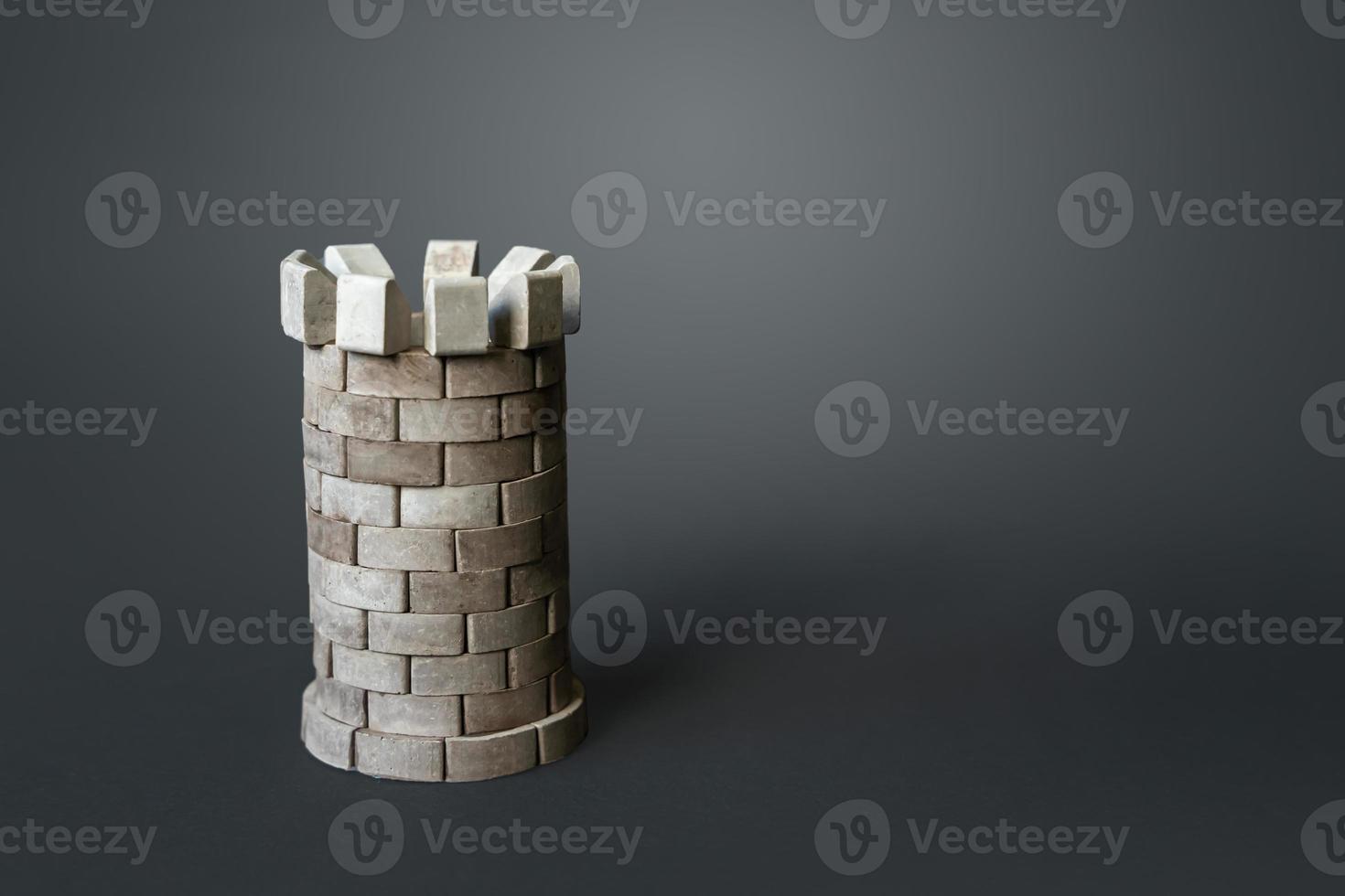 Medieval defense tower on a gray background. Safety, life and property insurance. The concept of resilience and strength. Durability, safety. Unbreakable. Alarms and active security equipment. photo