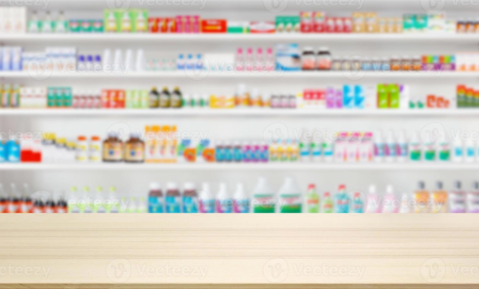Empty wood counter top with pharmacy drugstore shelves blur pharmaceutical medicine product background photo
