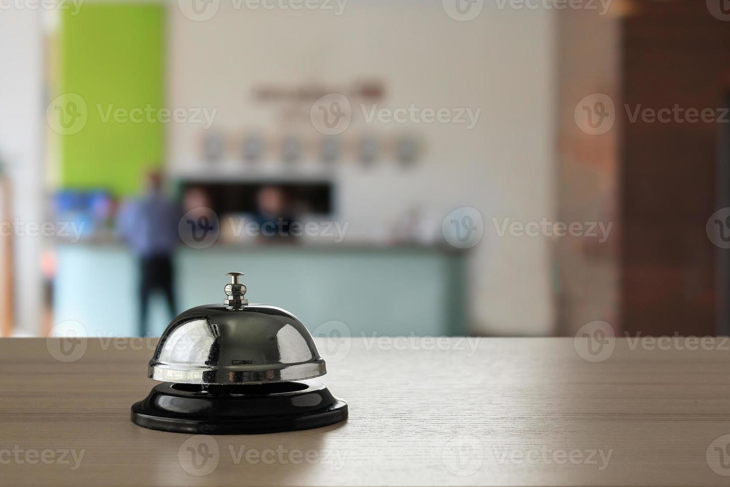 Hotel service bell on wood counter background photo