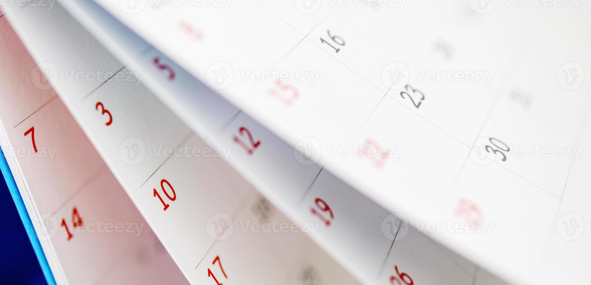 Calendar page flipping sheet close up on office table background business schedule planning appointment meeting concept photo