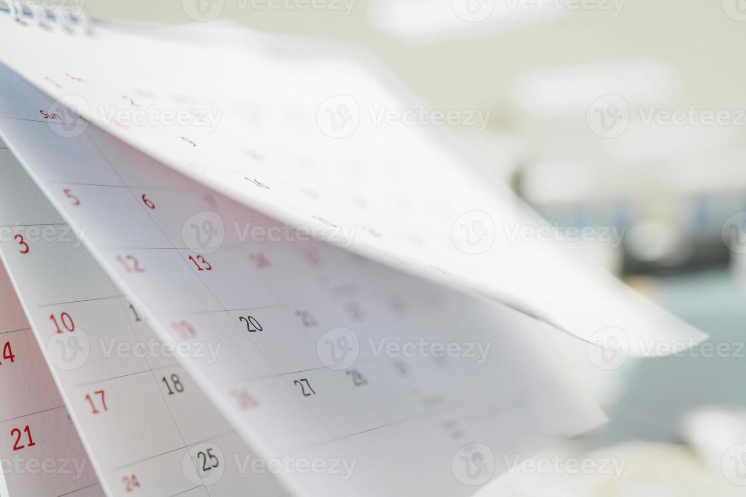 Calendar page flipping sheet close up on office table interior background business schedule planning appointment meeting concept photo