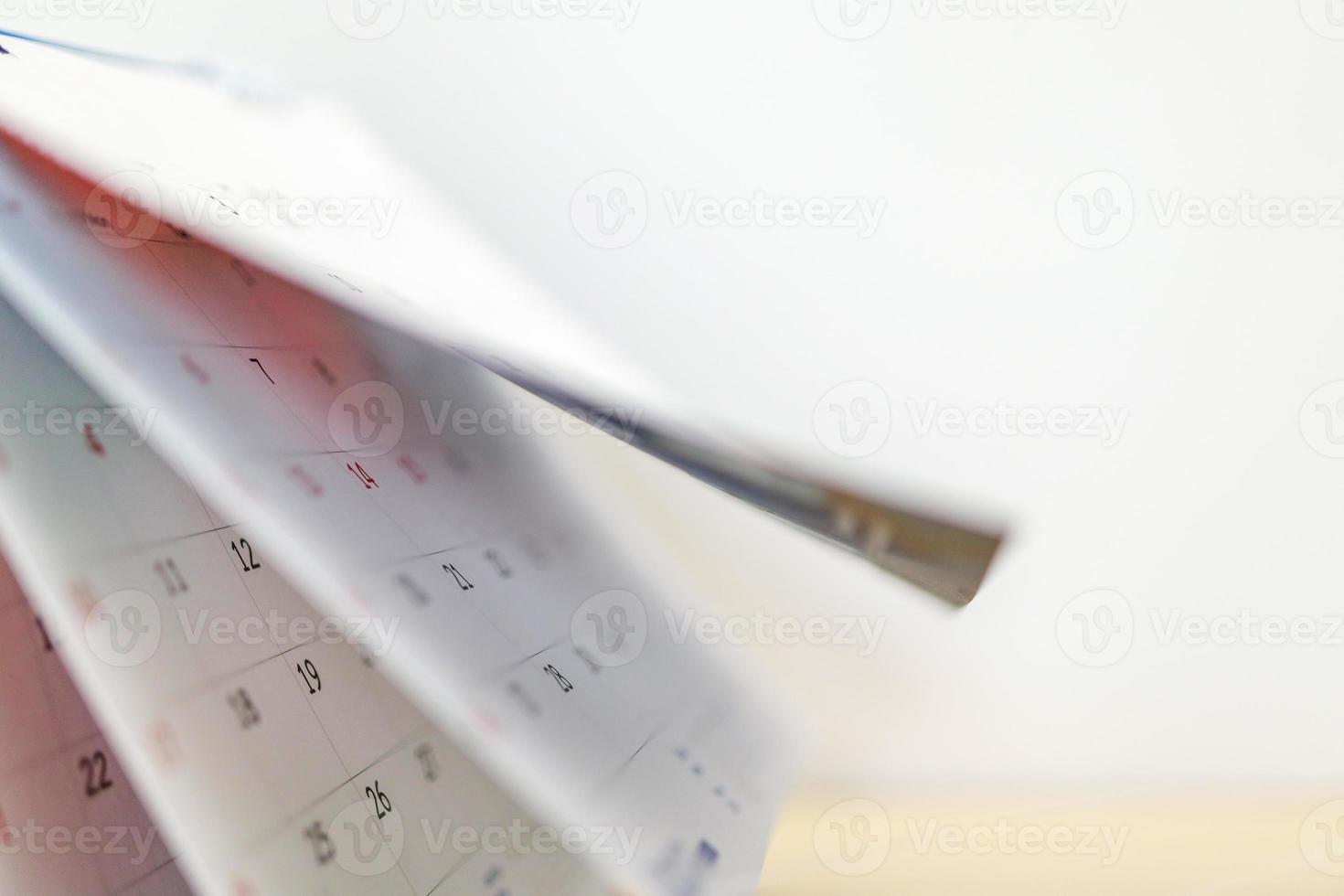 Calendar page flipping sheet close up on office table background business schedule planning appointment meeting concept photo