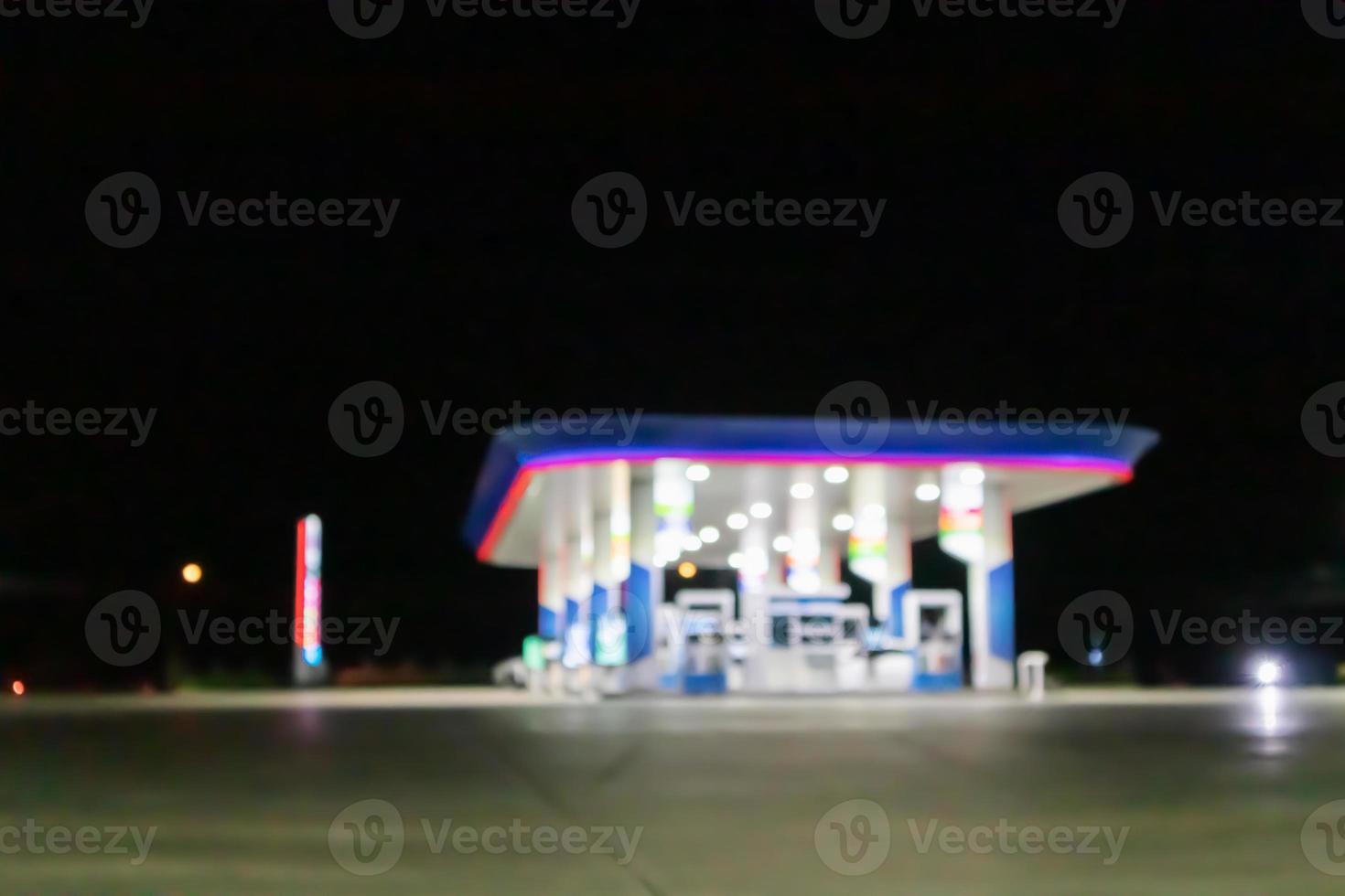 Petrol gas station at night time blurred background with bokeh light photo