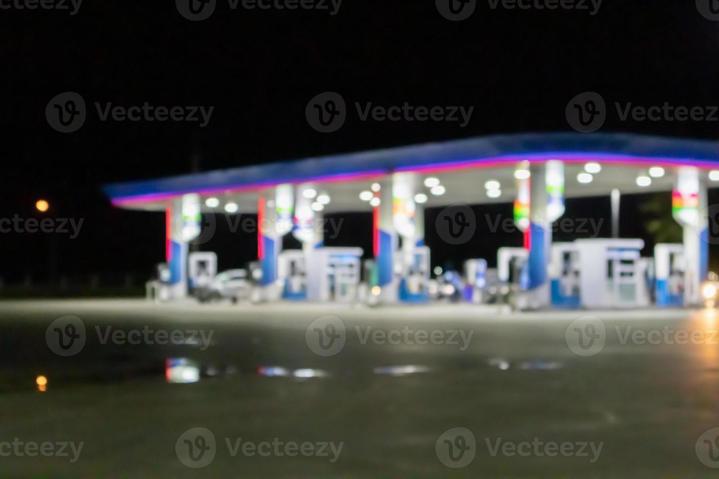 Petrol gas station at night time blurred background with bokeh light photo