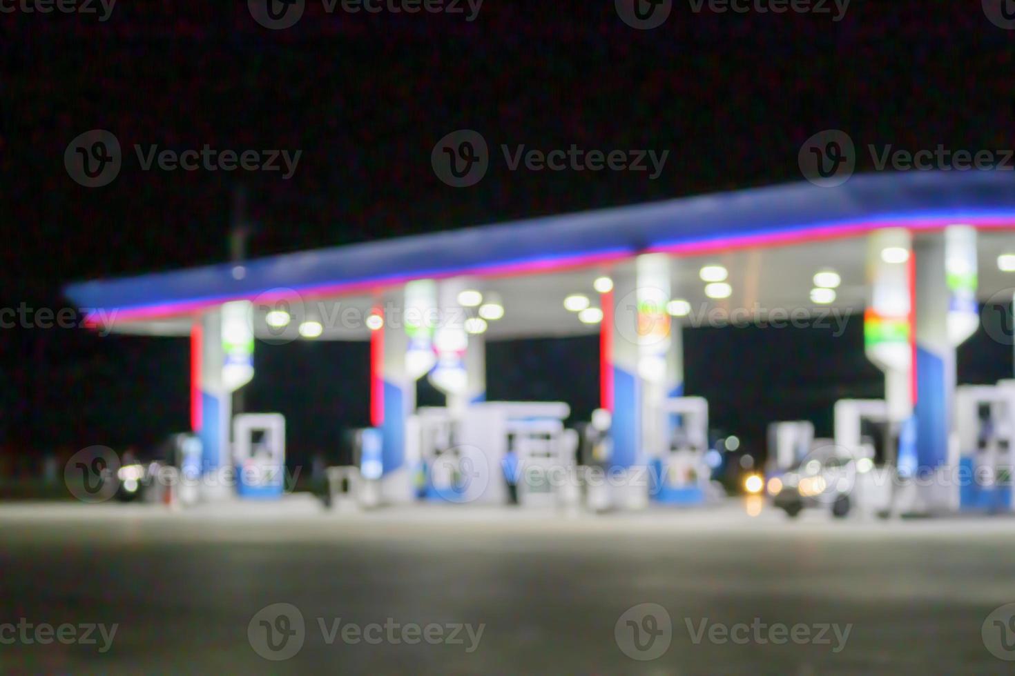 Petrol gas station at night time blurred background with bokeh light photo