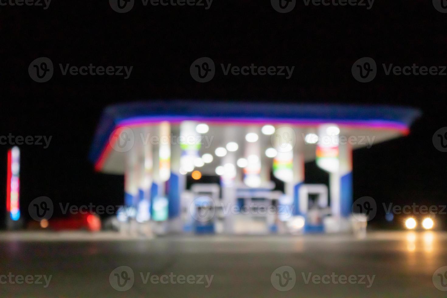 Petrol gas station at night time blurred background with bokeh light photo