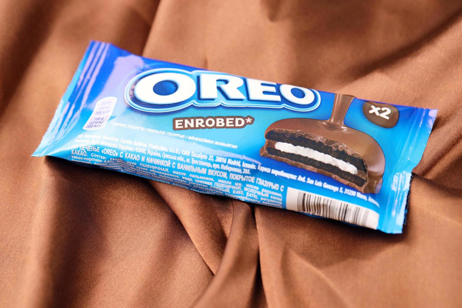 KHARKIV, UKRAINE - DECEMBER 16, 2021 Oreo enrobed chocolate snack cookies in wrapping with logo. Oreo is the best selling cookie brand in the United States. photo