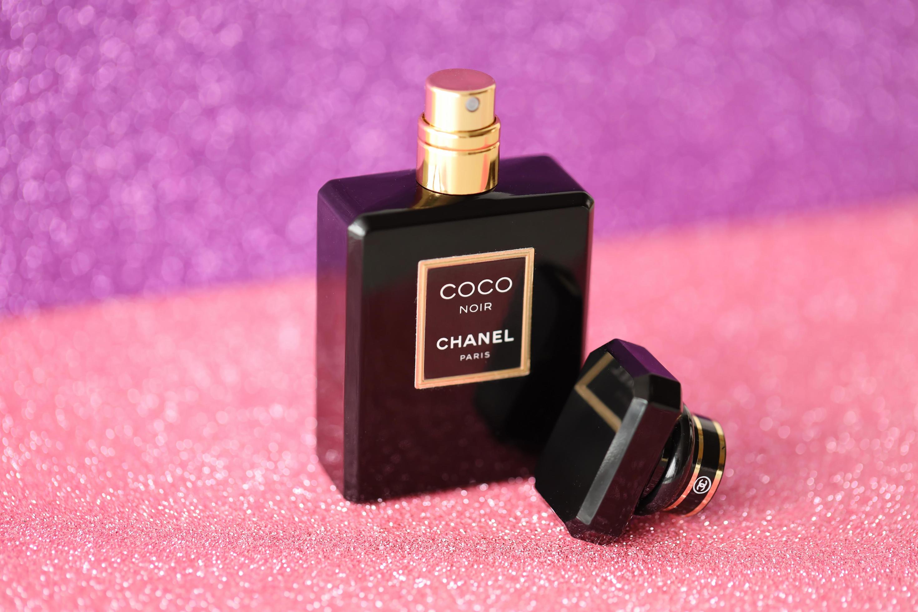 TERNOPIL UKRAINE SEPTEMBER 2 2022 Coco Noir Chanel Paris worldwide famous french perfume black bottle on shiny glitter background in purple colors 12887367 Stock Photo at Vecteezy