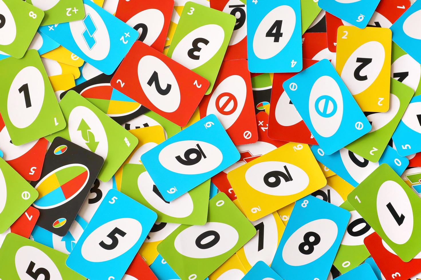 TERNOPIL, UKRAINE - MAY 15, 2022 Many colorful UNO game cards. UNO is an American shedding-type card game that is played with a specially printed deck photo